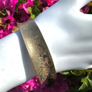 Gold tone patterned bangle bracelet